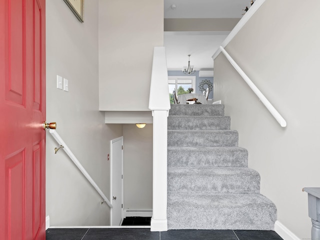 29 Washington Dr, Groton, CT 06340 - staircase with baseboards, tile patterned flooring, and a chandelier