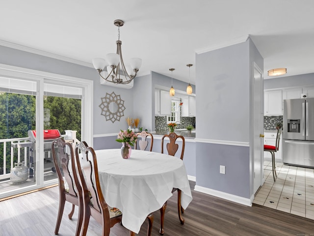 29 Washington Dr, Groton, CT 06340 - dining space featuring crown molding, light wood-style floors, baseboards, and a notable chandelier