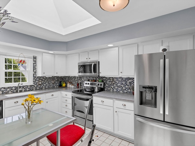29 Washington Dr, Groton, CT 06340 - kitchen featuring backsplash, appliances with stainless steel finishes, light tile patterned floors, and a sink