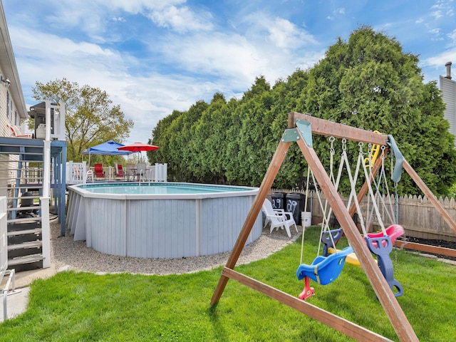 29 Washington Dr, Groton, CT 06340 - view of pool featuring a fenced backyard, a playground, a fenced in pool, and a lawn