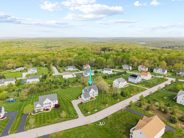 drone / aerial view featuring a forest view