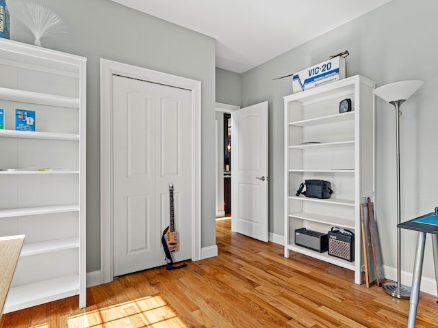 interior space featuring wood finished floors and baseboards