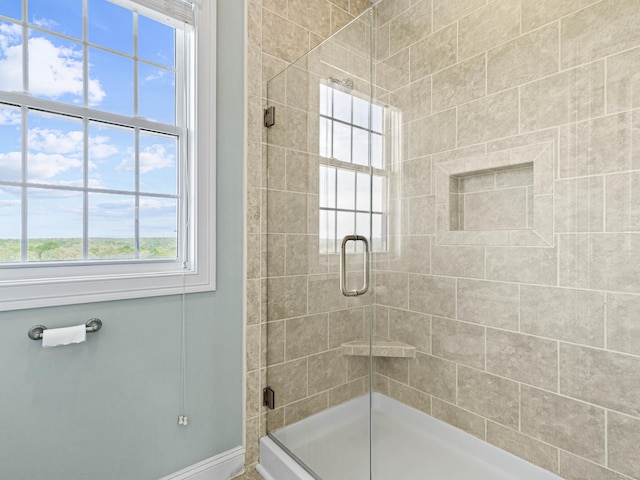full bath with baseboards and a shower stall