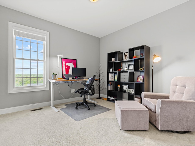office featuring baseboards, visible vents, and carpet