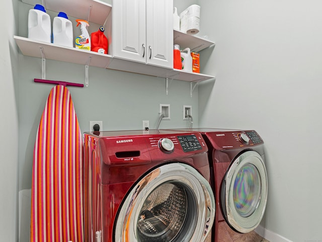 laundry room with cabinet space, separate washer and dryer, and baseboards