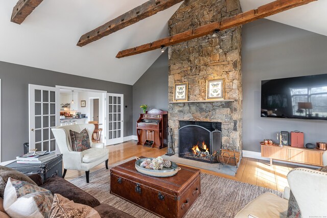 108 E St, Washington, CT 06793 - living area featuring a fireplace, beam ceiling, high vaulted ceiling, and wood finished floors