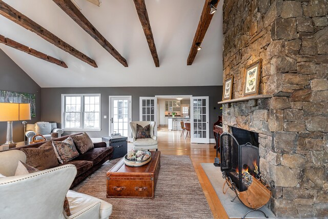 108 E St, Washington, CT 06793 - living room with a stone fireplace, wood finished floors, beamed ceiling, and high vaulted ceiling