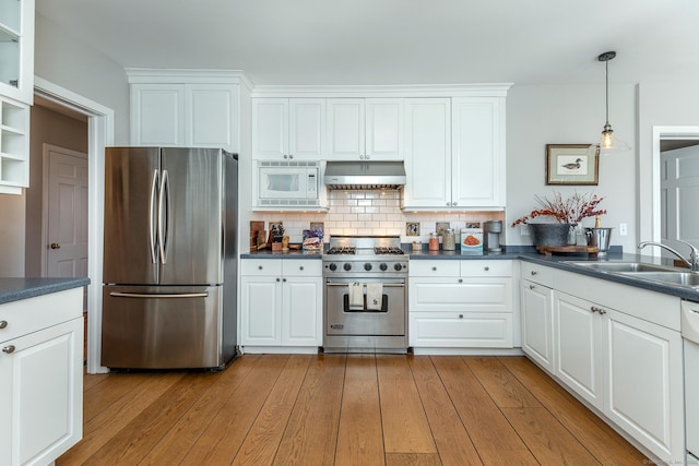 108 E St, Washington, CT 06793 - kitchen featuring under cabinet range hood, a sink, dark countertops, tasteful backsplash, and appliances with stainless steel finishes