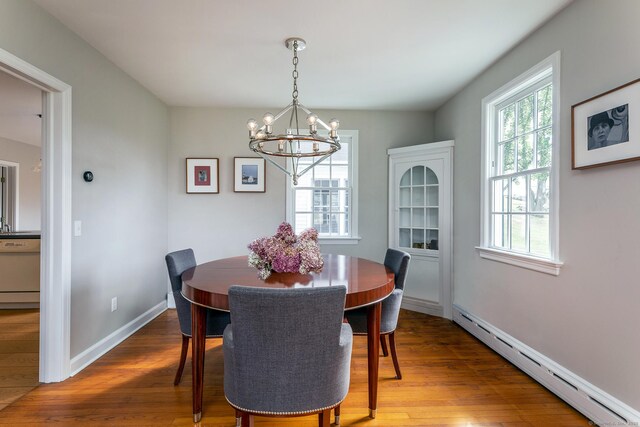 108 E St, Washington, CT 06793 - dining area featuring an inviting chandelier, wood finished floors, baseboards, and a baseboard heating unit