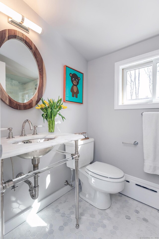 108 E St, Washington, CT 06793 - bathroom with tile patterned floors, toilet, a baseboard heating unit, and a sink