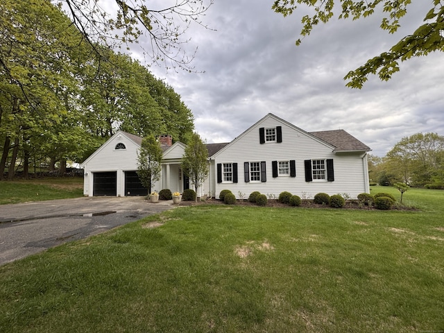 108 E St, Washington, CT 06793 - view of front facade featuring asphalt driveway, a front lawn, an attached garage, roof with shingles, and a chimney
