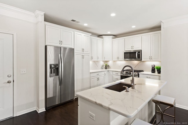 kitchen featuring stainless steel appliances, baseboards, white cabinetry, visible vents, and dark wood-style floors