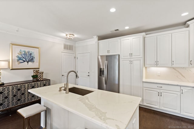 kitchen with a sink, stainless steel fridge with ice dispenser, dark wood-type flooring, and visible vents