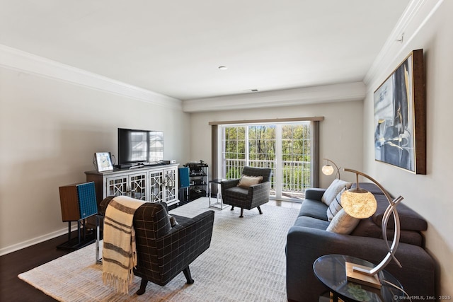 living area with crown molding, baseboards, and wood finished floors
