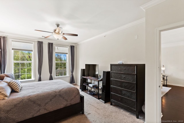 bedroom featuring baseboards, ornamental molding, and a ceiling fan