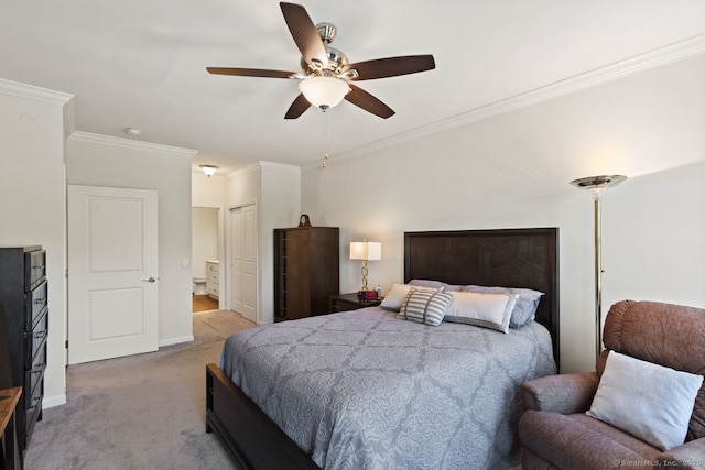 bedroom with crown molding, carpet floors, baseboards, ensuite bathroom, and ceiling fan