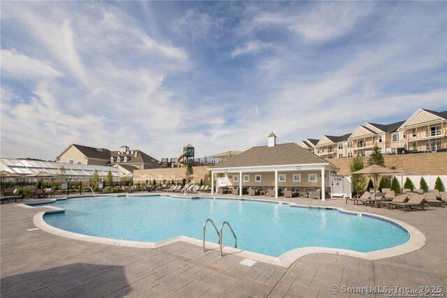pool with fence, a residential view, and a patio area