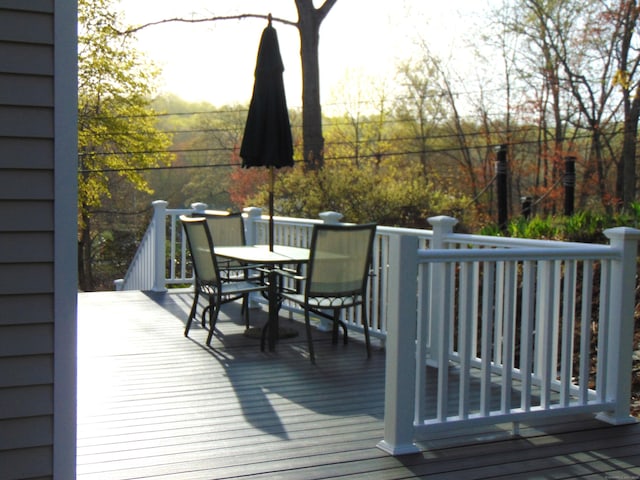 wooden terrace featuring outdoor dining space