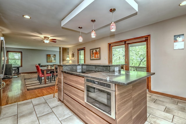 1540 Paradise Ave, Hamden, CT 06514 - kitchen featuring black electric stovetop, baseboards, light tile patterned floors, a kitchen island, and recessed lighting