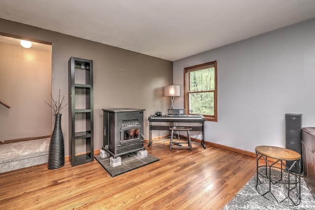 1540 Paradise Ave, Hamden, CT 06514 - sitting room featuring wood finished floors, a wood stove, and baseboards