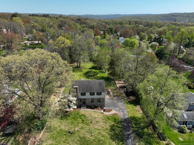 birds eye view of property with a forest view