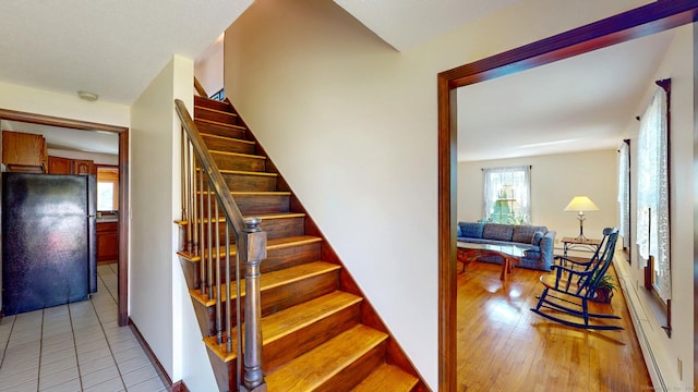 stairs with baseboards and wood finished floors