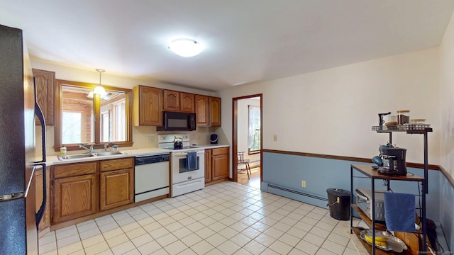 kitchen with brown cabinetry, light countertops, a baseboard heating unit, a sink, and black appliances