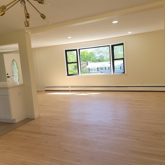 91 Jennifer Rd, Hamden, CT 06514 - empty room with light wood-type flooring, baseboard heating, recessed lighting, and baseboards