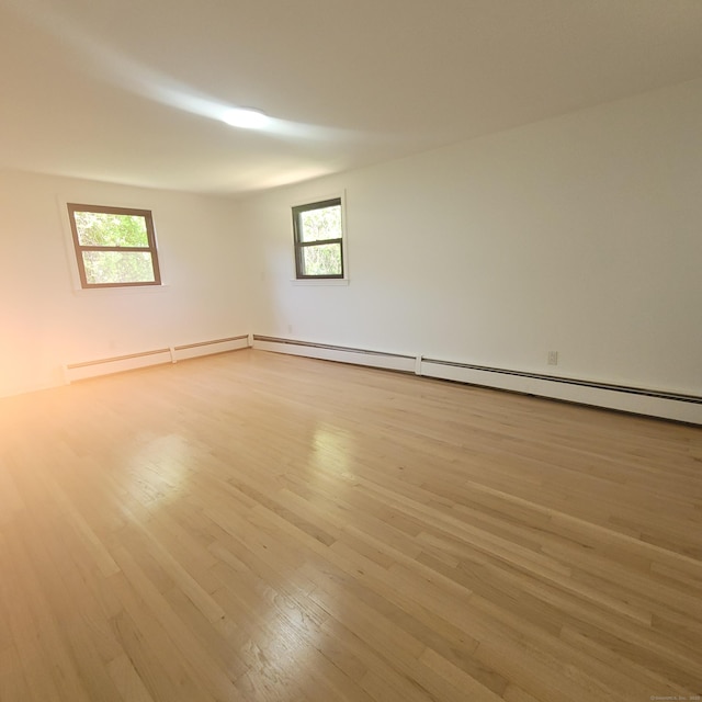 91 Jennifer Rd, Hamden, CT 06514 - empty room featuring hardwood / wood-style flooring, healthy amount of natural light, baseboard heating, and a baseboard heating unit