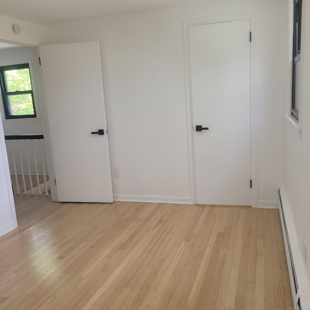 91 Jennifer Rd, Hamden, CT 06514 - unfurnished room featuring baseboard heating and light wood-style floors