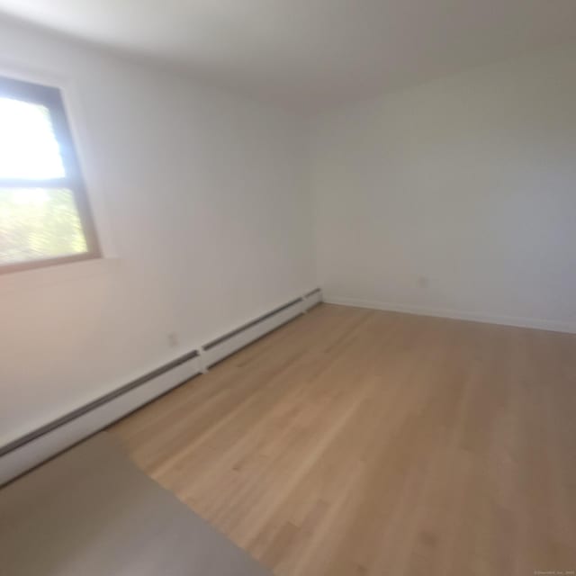 91 Jennifer Rd, Hamden, CT 06514 - spare room with baseboard heating, light wood finished floors, and baseboards