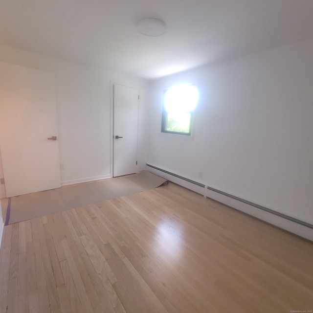 91 Jennifer Rd, Hamden, CT 06514 - empty room featuring baseboard heating and light wood finished floors