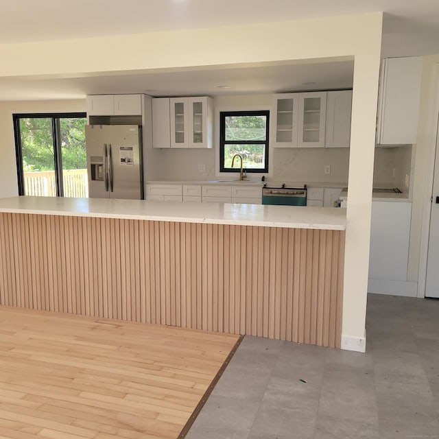 91 Jennifer Rd, Hamden, CT 06514 - kitchen featuring stainless steel fridge with ice dispenser, a sink, light countertops, and plenty of natural light