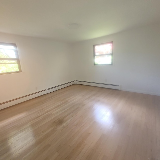 91 Jennifer Rd, Hamden, CT 06514 - empty room with healthy amount of natural light, light wood-type flooring, and baseboard heating
