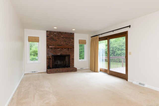 39 Amato Cir, Southington, CT 06489 - unfurnished living room featuring carpet flooring, baseboards, a brick fireplace, and recessed lighting