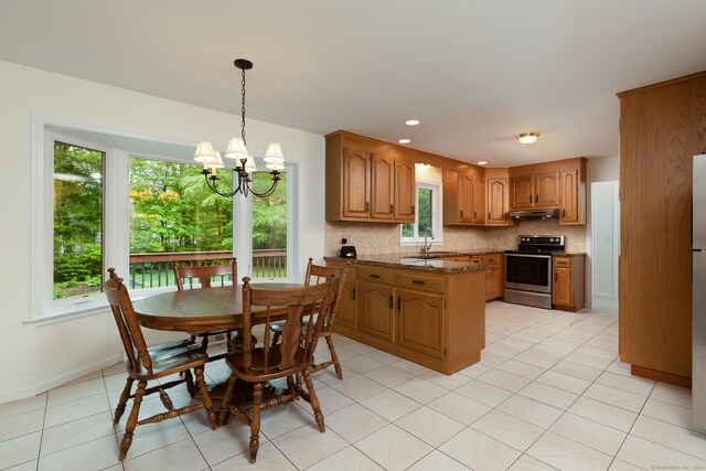 39 Amato Cir, Southington, CT 06489 - kitchen featuring electric stove, under cabinet range hood, a sink, decorative backsplash, and brown cabinets