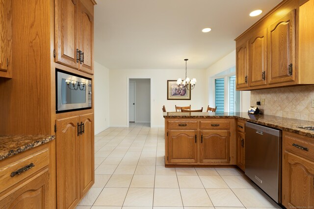 39 Amato Cir, Southington, CT 06489 - kitchen with appliances with stainless steel finishes, a peninsula, brown cabinets, backsplash, and a chandelier