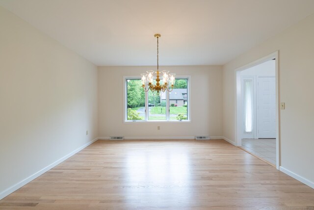 39 Amato Cir, Southington, CT 06489 - unfurnished room with a chandelier, light wood-style flooring, and baseboards