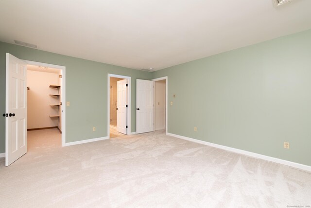 39 Amato Cir, Southington, CT 06489 - unfurnished bedroom featuring a spacious closet, baseboards, light colored carpet, and ensuite bath