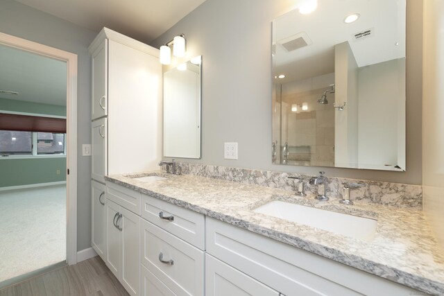 39 Amato Cir, Southington, CT 06489 - full bathroom with double vanity, a tile shower, wood finished floors, baseboards, and recessed lighting