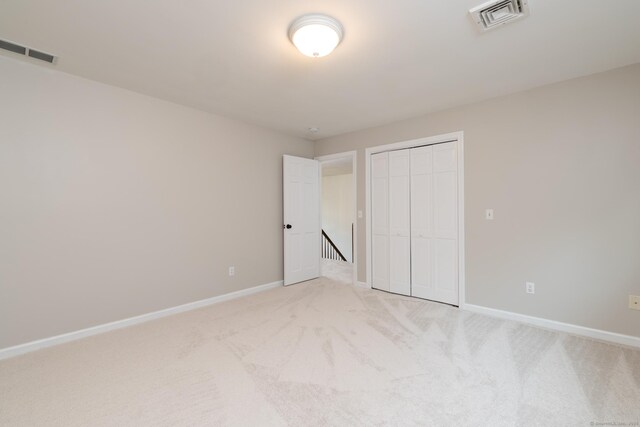 39 Amato Cir, Southington, CT 06489 - unfurnished bedroom with light carpet, baseboards, and a closet