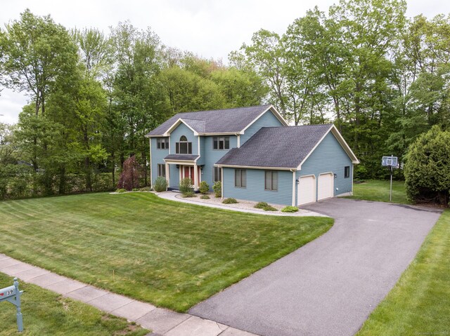 39 Amato Cir, Southington, CT 06489 - view of front of home featuring asphalt driveway, an attached garage, a front lawn, a shingled roof, and view of scattered trees