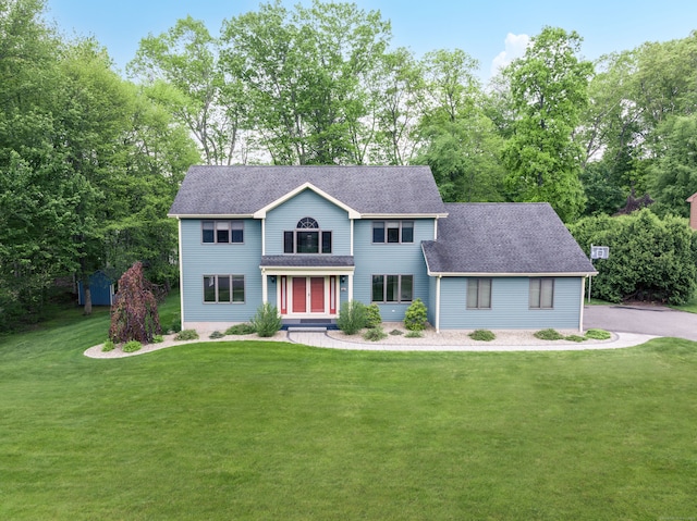 39 Amato Cir, Southington, CT 06489 - view of front of property featuring a front yard, a shingled roof, view of wooded area, and a porch
