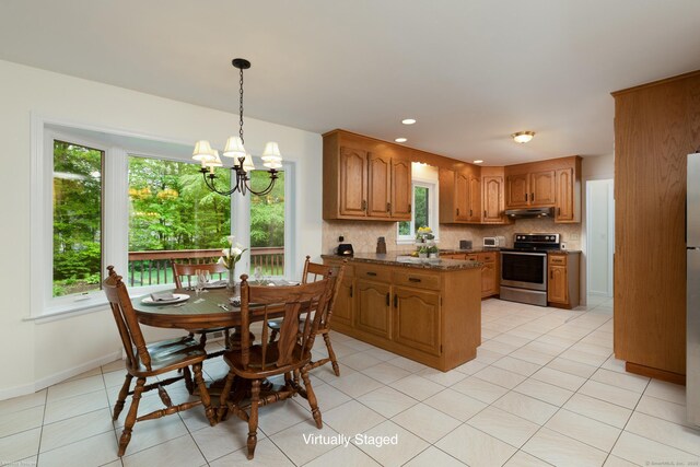 39 Amato Cir, Southington, CT 06489 - kitchen with stainless steel electric range, under cabinet range hood, a peninsula, backsplash, and brown cabinetry
