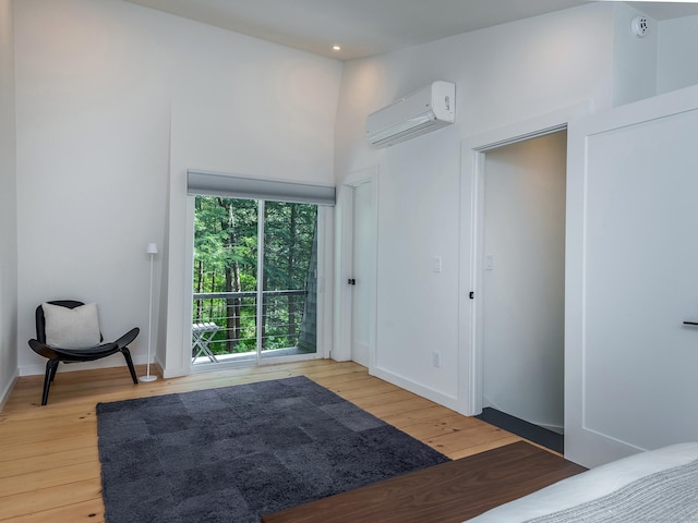 19 Spargo Rd, Roxbury, CT 06783 - bedroom with an AC wall unit, hardwood / wood-style floors, baseboards, recessed lighting, and access to outside