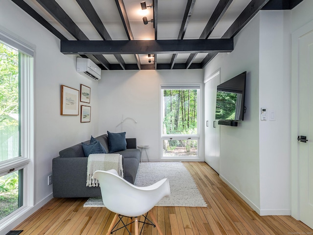 19 Spargo Rd, Roxbury, CT 06783 - living room featuring beamed ceiling, a wall mounted air conditioner, light wood finished floors, and baseboards