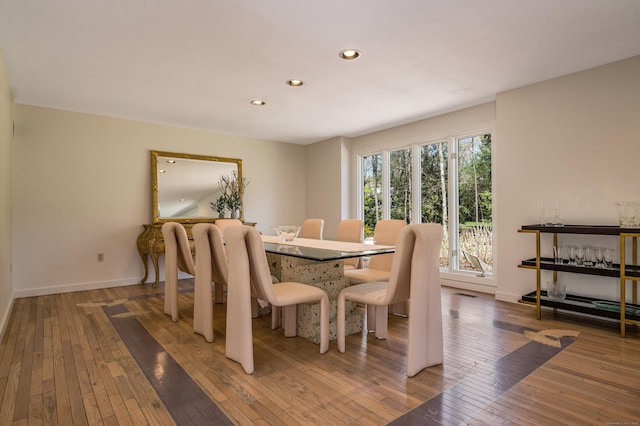 dining space with recessed lighting, baseboards, and hardwood / wood-style floors