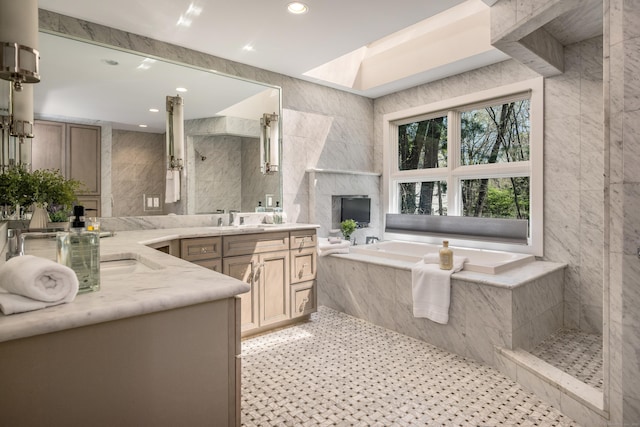 full bathroom featuring a premium fireplace, recessed lighting, tile walls, and a garden tub