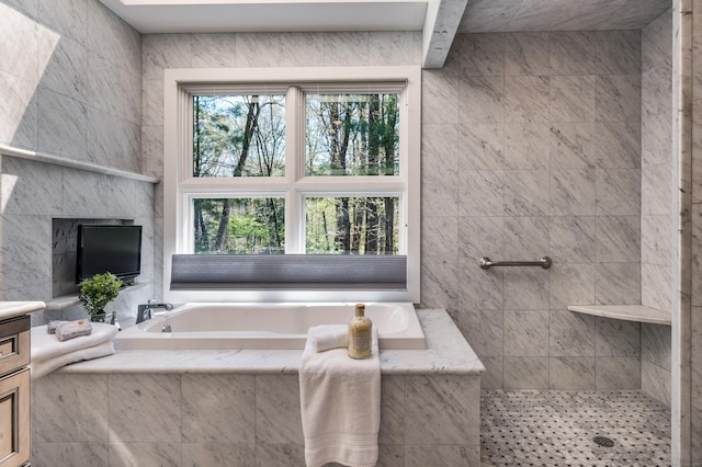 full bath featuring tiled shower, a garden tub, and vanity