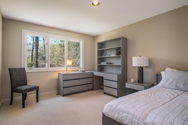 bedroom featuring baseboards and light colored carpet